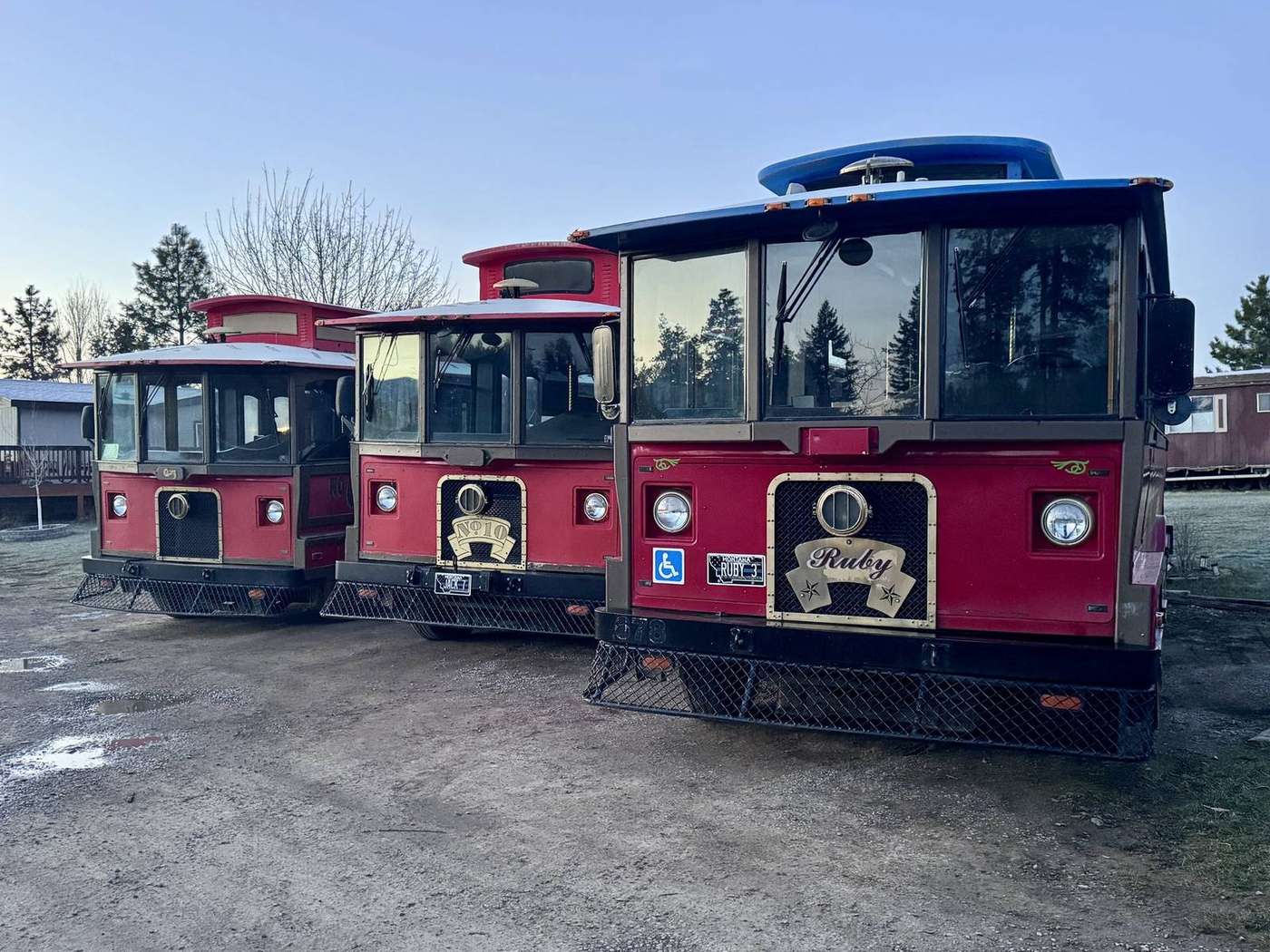 Two Montana Trolley Company Big Red trolleys parked side by side