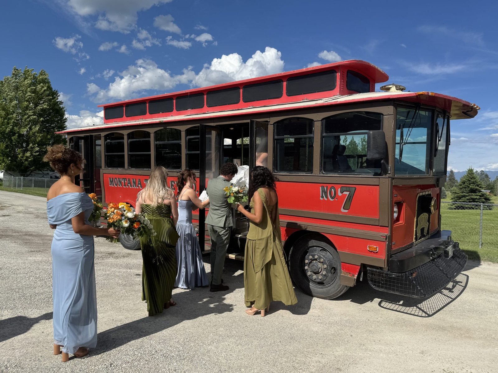 Bridal party gathered beside Jack the red trolley
