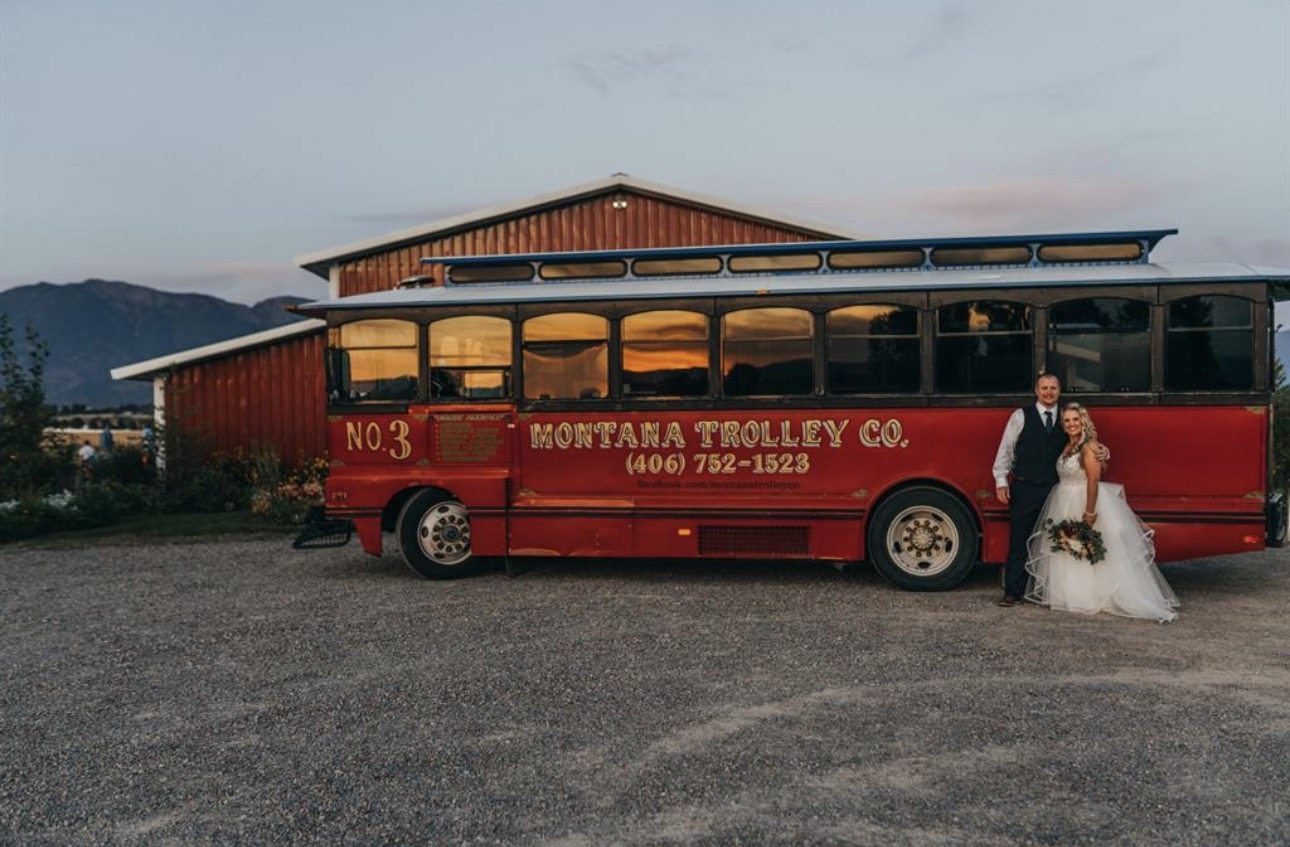 Couple with a Montana trolley at dusk, a Flathead celebration moment